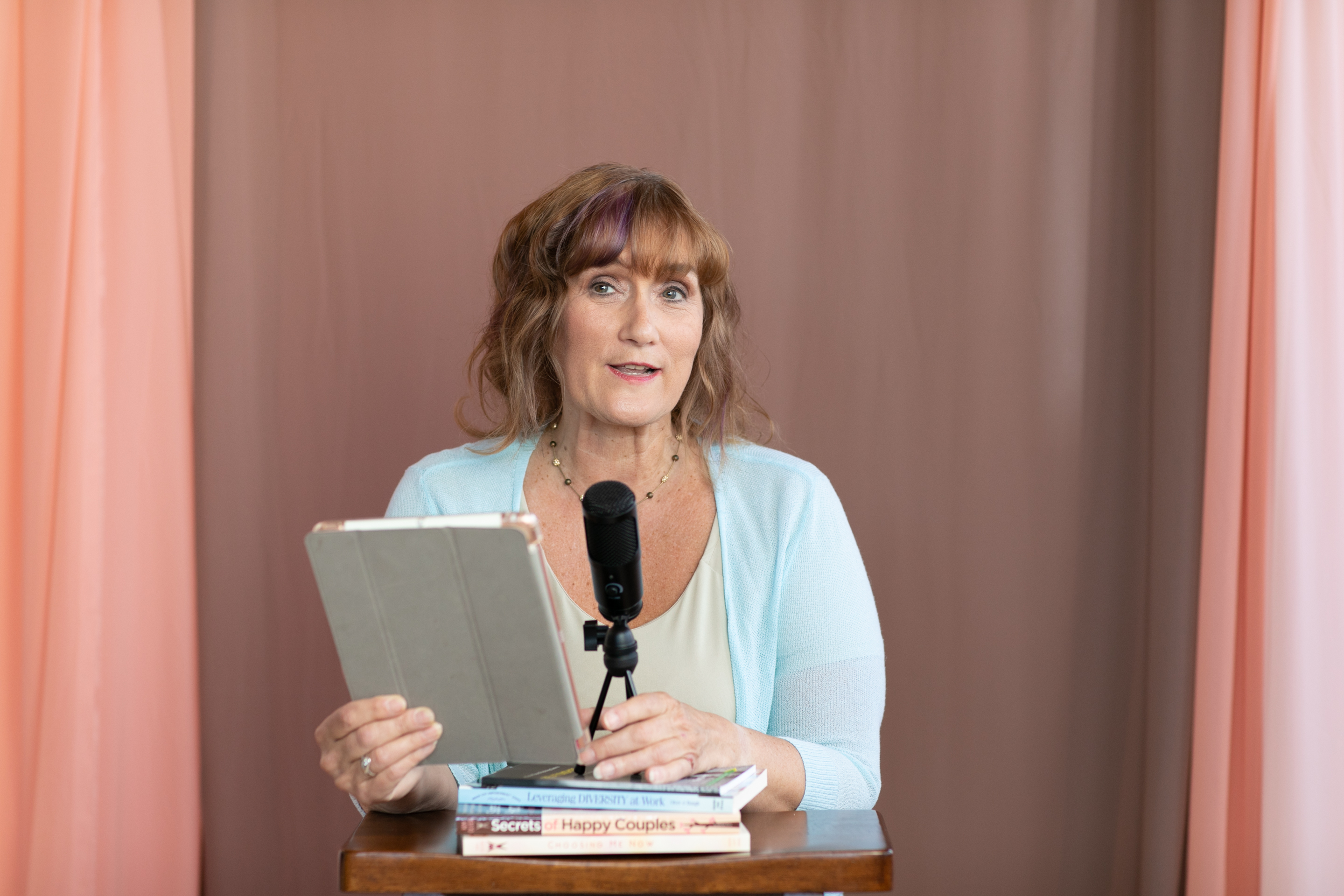 Kim smiling while holding a tablet